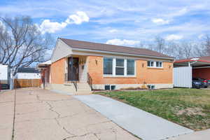 Bungalow-style home with brick siding