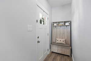 Mudroom with dark wood finished floors and baseboards