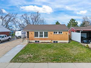 Ranch-style house with a front lawn and brick siding