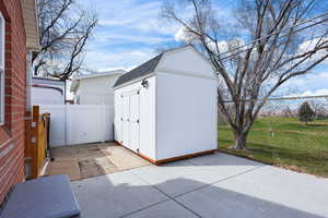 View of shed featuring a fenced backyard