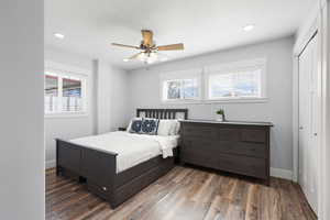 Bedroom with recessed lighting, dark wood-type flooring, a ceiling fan, and a closet
