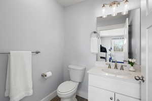 Bathroom featuring vanity and dark wood-type flooring