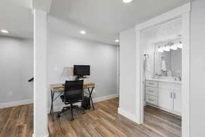 Office space featuring a textured ceiling, light wood-style floors, and recessed lighting