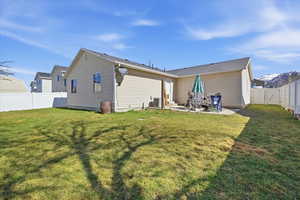 Rear view of property with a fenced backyard, a patio, and a gate