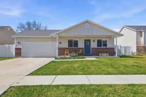 View of front of home featuring brick siding, a porch, a garage, and driveway