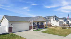 View of front of house with brick siding, a porch, an attached garage, a front lawn, and concrete driveway