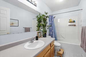 Bathroom with vanity and shower / tub combo