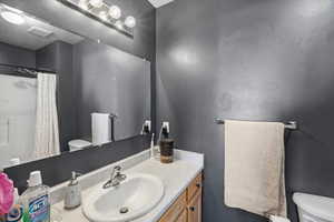 Bathroom with vanity and a shower with shower curtain