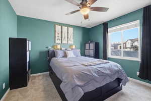 Bedroom with light carpet and ceiling fan
