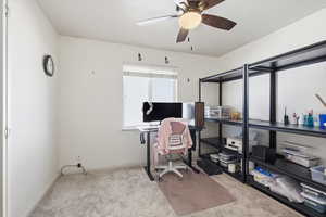 Office space featuring light carpet and ceiling fan