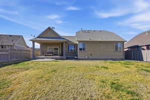 Back of house with a fenced backyard, a patio, and a shingled roof