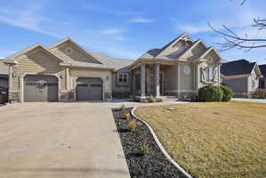 Craftsman house with stone siding, concrete driveway, an attached garage, and a shingled roof