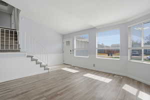 Foyer with stairway and light wood-type flooring