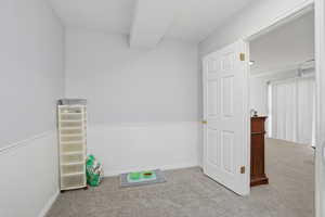 Game room featuring light carpet and a textured ceiling