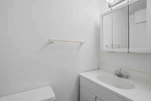 Bathroom featuring vanity and toilet