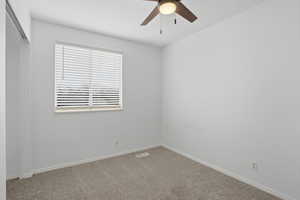 Spare room with carpet flooring and a ceiling fan