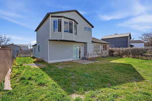 Rear view of house featuring a fenced backyard
