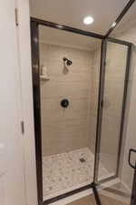 Bathroom featuring a shower stall and recessed lighting