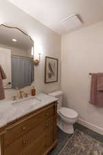 Bathroom featuring vanity and curtained shower