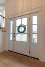 Doorway to outside featuring wood finished floors and healthy amount of natural light