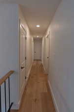 Hallway featuring light wood-style floors and recessed lighting