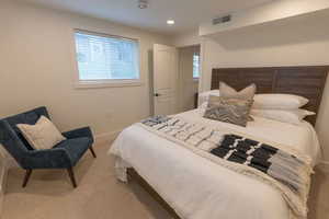 Carpeted bedroom with baseboards and recessed lighting