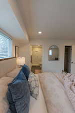 Bedroom with recessed lighting and connected bathroom