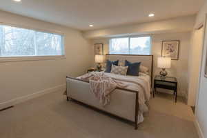 Carpeted bedroom featuring recessed lighting and baseboards