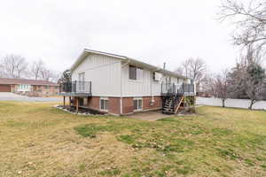 View of side of property featuring a patio area, board and batten siding, and a wooden deck