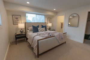 Bedroom featuring recessed lighting, carpet, and ensuite bathroom