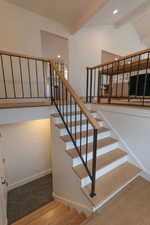 Staircase with beam ceiling and recessed lighting