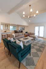 Living room featuring light wood-style flooring and a chandelier