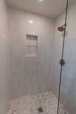 Bathroom featuring a tile shower