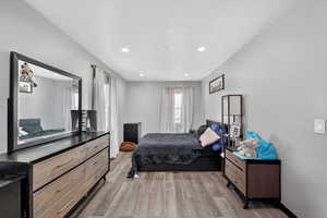 Bedroom with light wood-style floors and recessed lighting