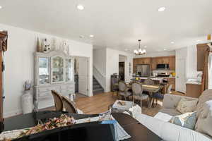 Living room featuring light wood-type flooring and a chandelier