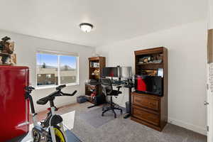 Bedroom featuring light carpet and baseboards