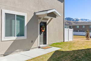 Doorway to property with a mountain view and stucco siding
