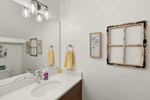 Half bath with vanity and toilet