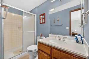 Full bathroom featuring vanity, a stall shower, and light tile patterned floors