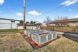 Fenced backyard with a vegetable garden