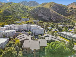 Bird's eye view of a mountainous background and apartment complex / building