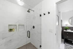 Bathroom with a marble finish shower