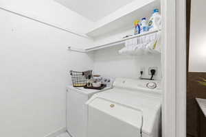 Laundry room with washing machine and dryer and baseboards