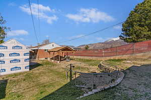 Fenced backyard featuring a patio and a mountain view