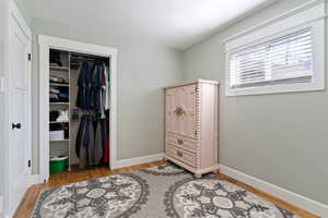 Bedroom with light wood-type flooring and a closet