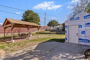Fenced backyard with a patio area and area for grilling