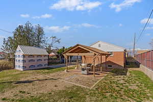 Back of property with a patio, a fenced backyard, and an outdoor structure