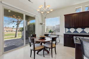 Dining room featuring suspended lighting and light tile patterned floors