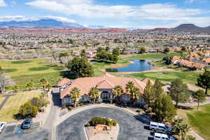 Aerial perspective of suburban area with a golf course and a water and mountain view