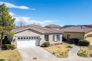 Mediterranean / spanish-style home with stucco siding, a garage, and concrete driveway